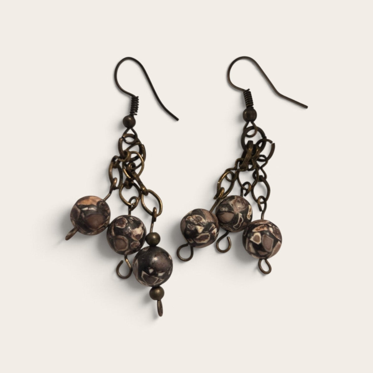 Blanca Closet handcrafted bead earrings featuring brown patterned stone beads on antique bronze metal chains