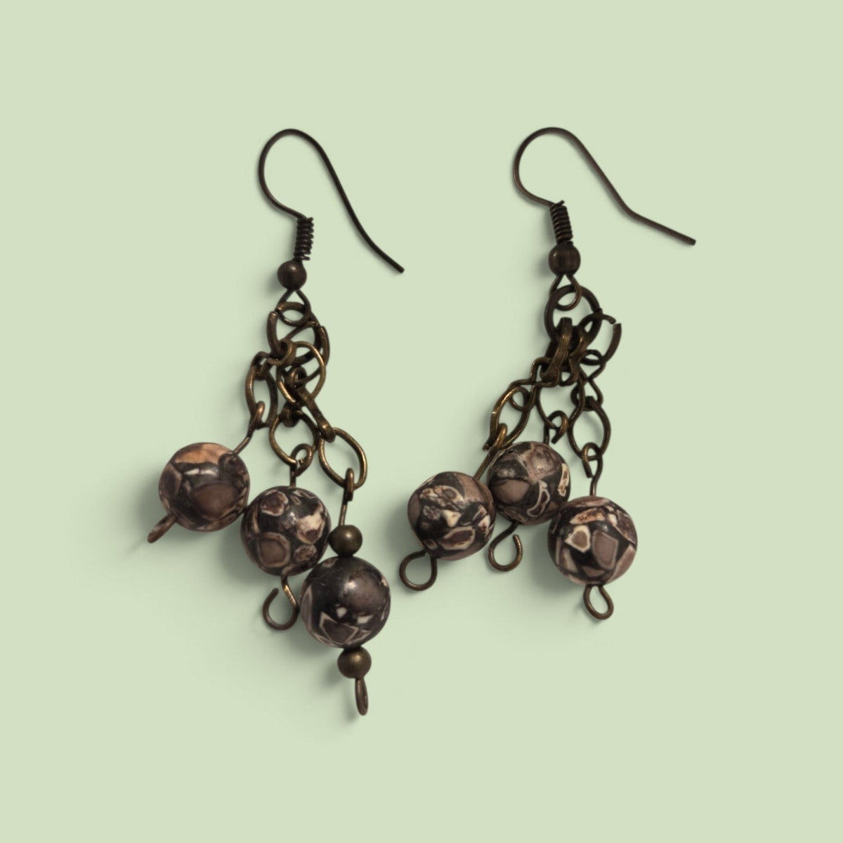 Blanca Closet handcrafted dangle earrings with three patterned brown stone beads and antique bronze metal chains.