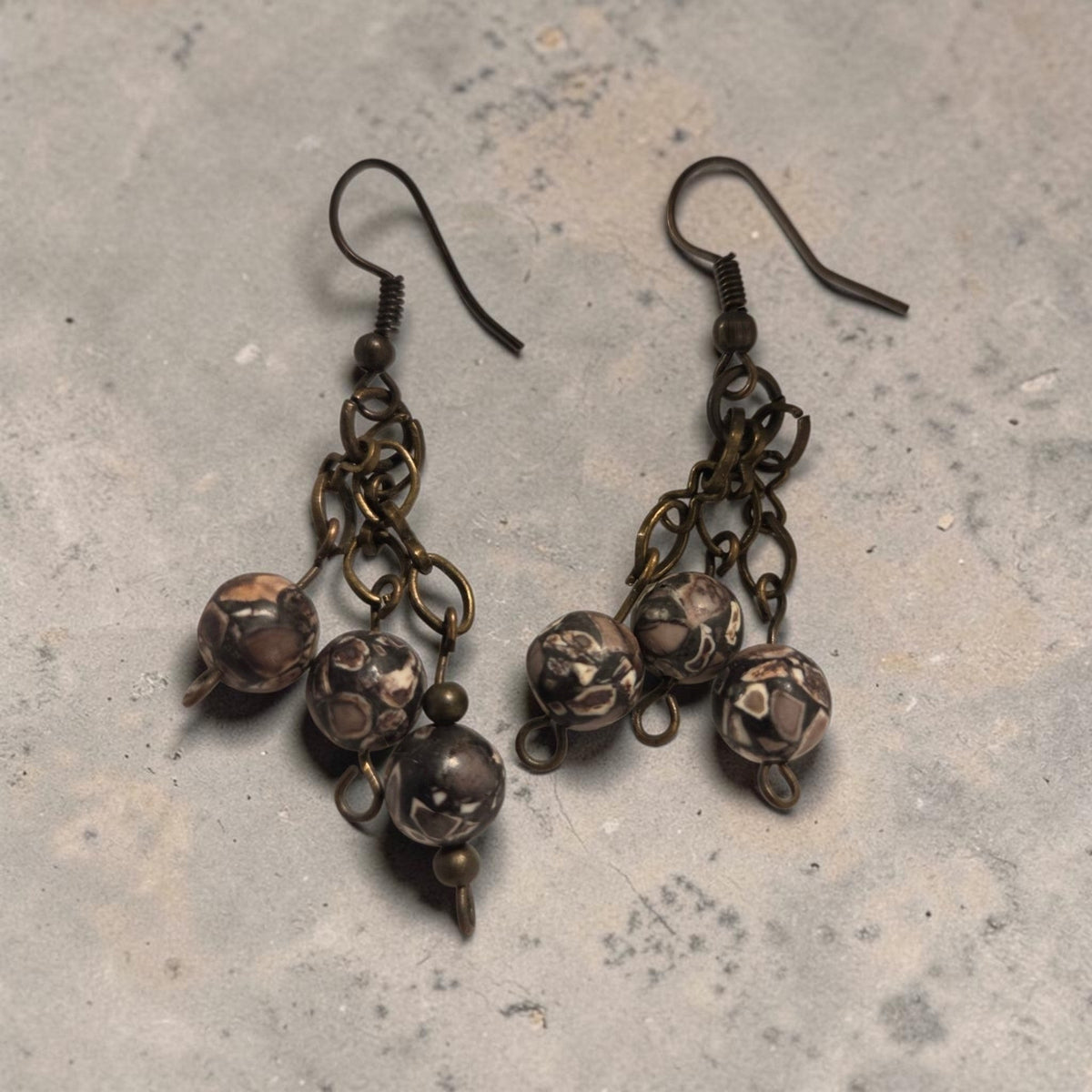 Blanca Closet handcrafted bead earrings featuring brown patterned stone beads on antique bronze metal chains.