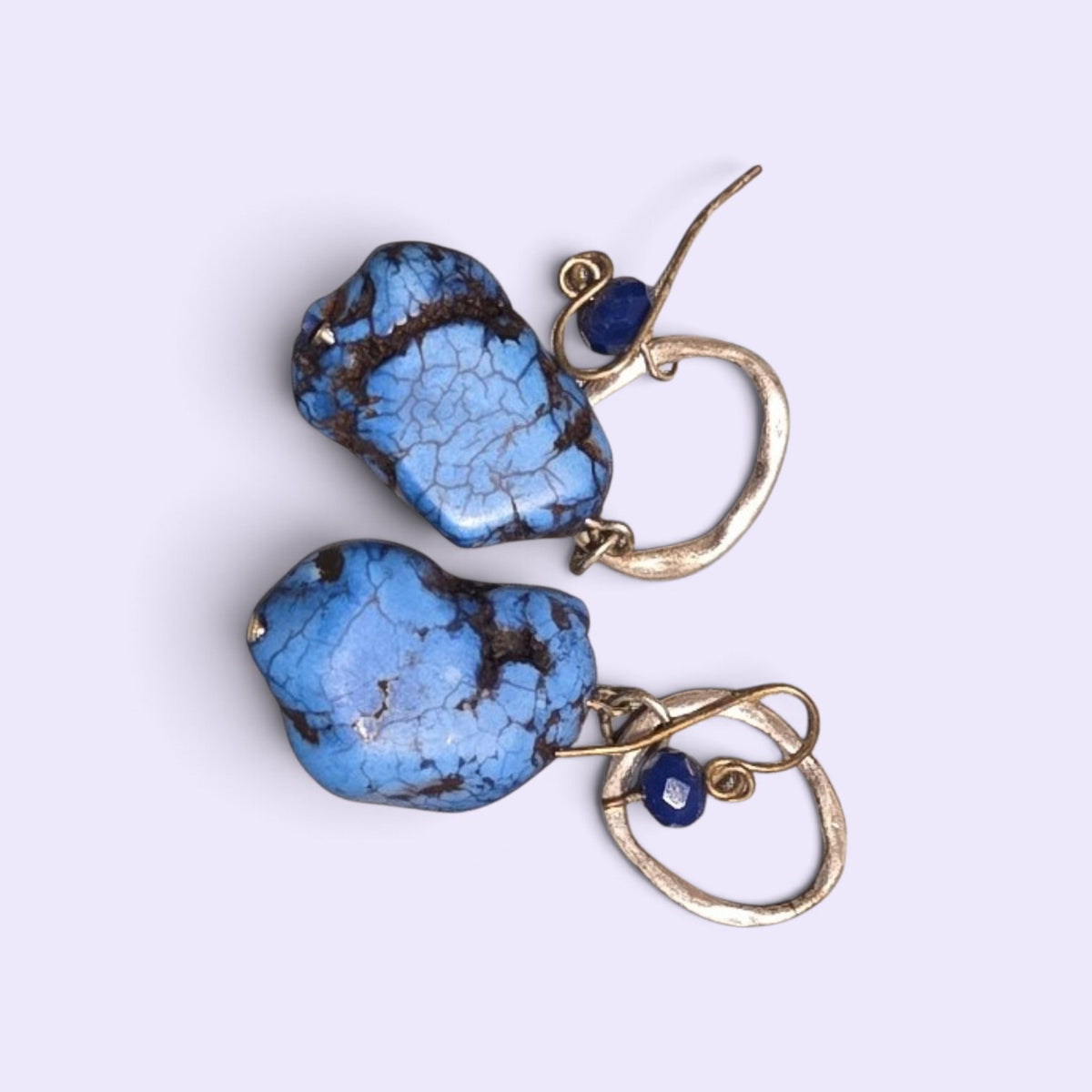 Blanca Closet blue turquoise drop earrings with raw stone pendants and gold-tone metal hooks on a light background.