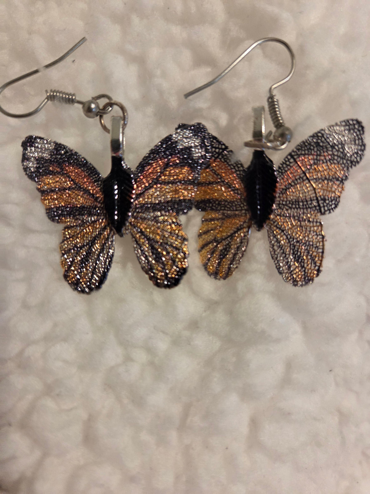 Blanca Closet brown butterfly earrings with delicate textured wing details on silver-toned hooks.
