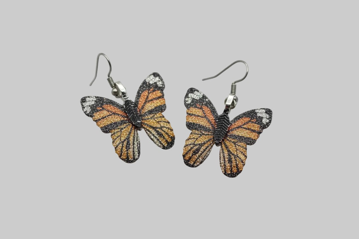 Blanca Closet brown butterfly earrings with detailed orange and black wing patterns on silver-tone drop hooks.