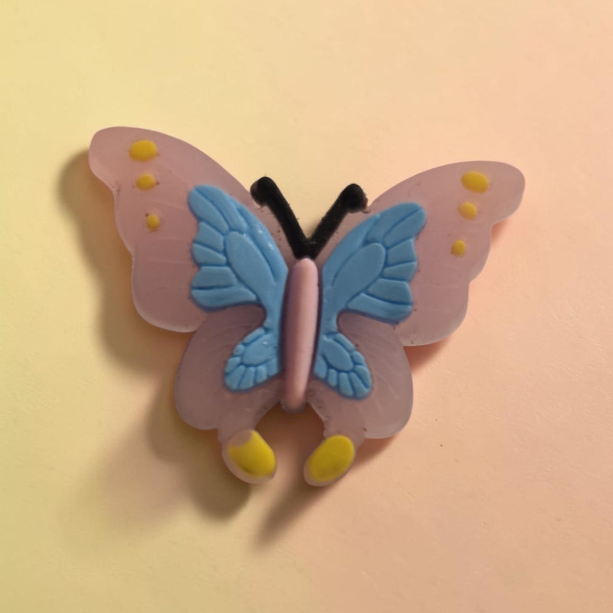 Blanca Closet butterfly charm for Croc sandals in pastel pink, blue, and yellow for personalized footwear decoration