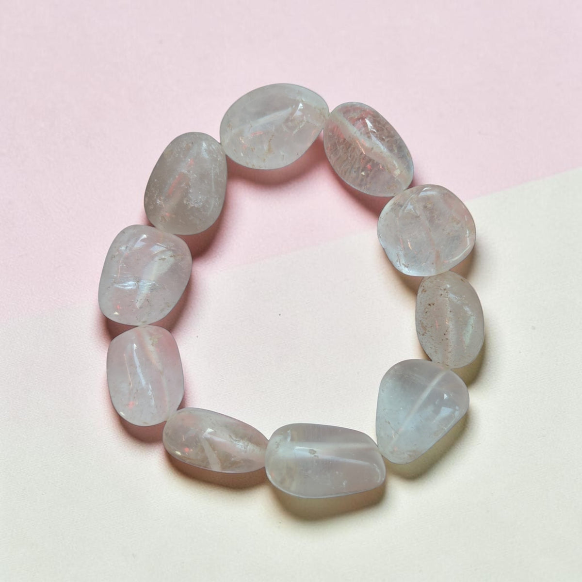 Blanca Closet crystal quartz bracelet featuring polished, clear tumbled stones on a soft pink and cream background.