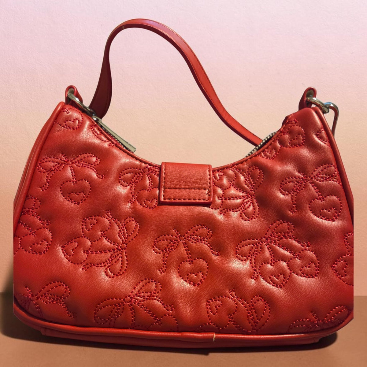 Blanca Closet red purse featuring a quilted cherry pattern and a single shoulder strap for a stylish look.
