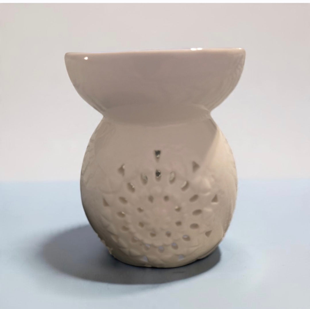 Blanca Closet white ceramic wax and oil warmer featuring a delicate laser-cut floral pattern for home fragrance.