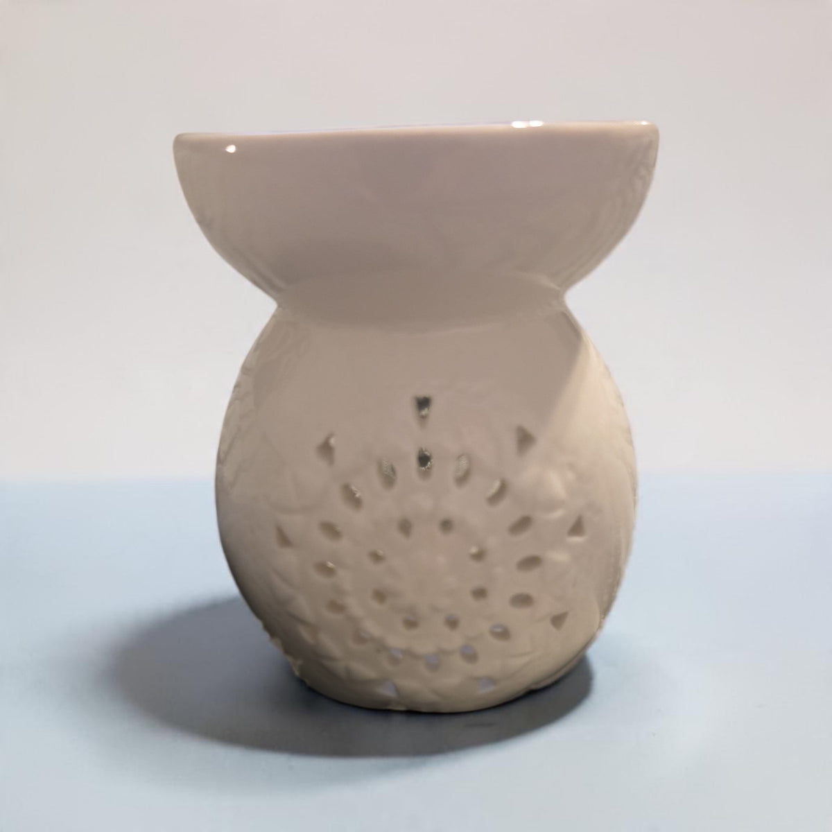 Blanca Closet white ceramic wax warmer with intricate mandala-style cutouts for essential oils and wax melts